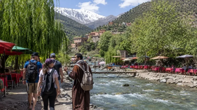 Hikers walking through a scenic Atlas Mountain valley near Ourika